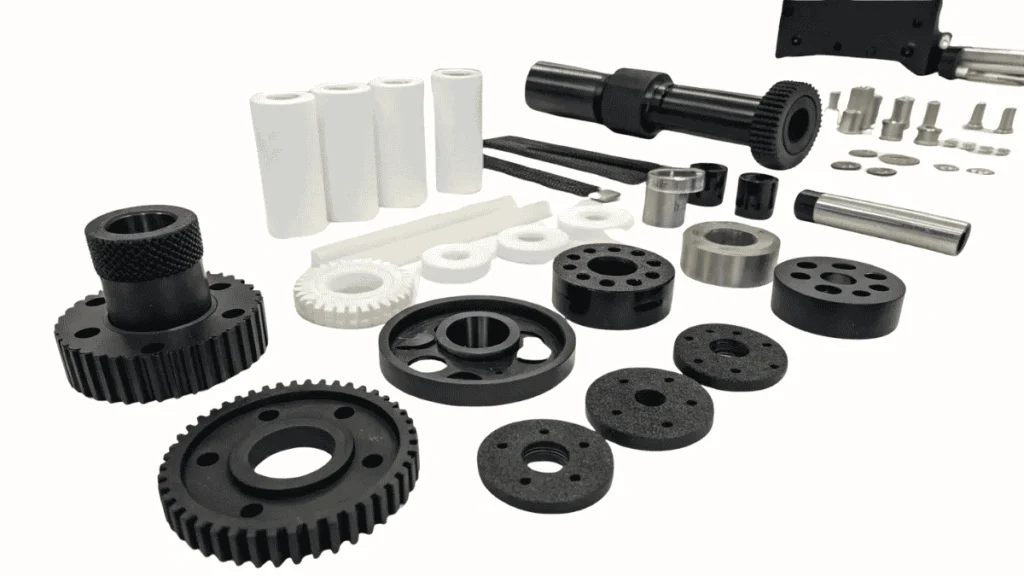 An image showing Nylon gears, bushings, washers, and other CNC-machined parts