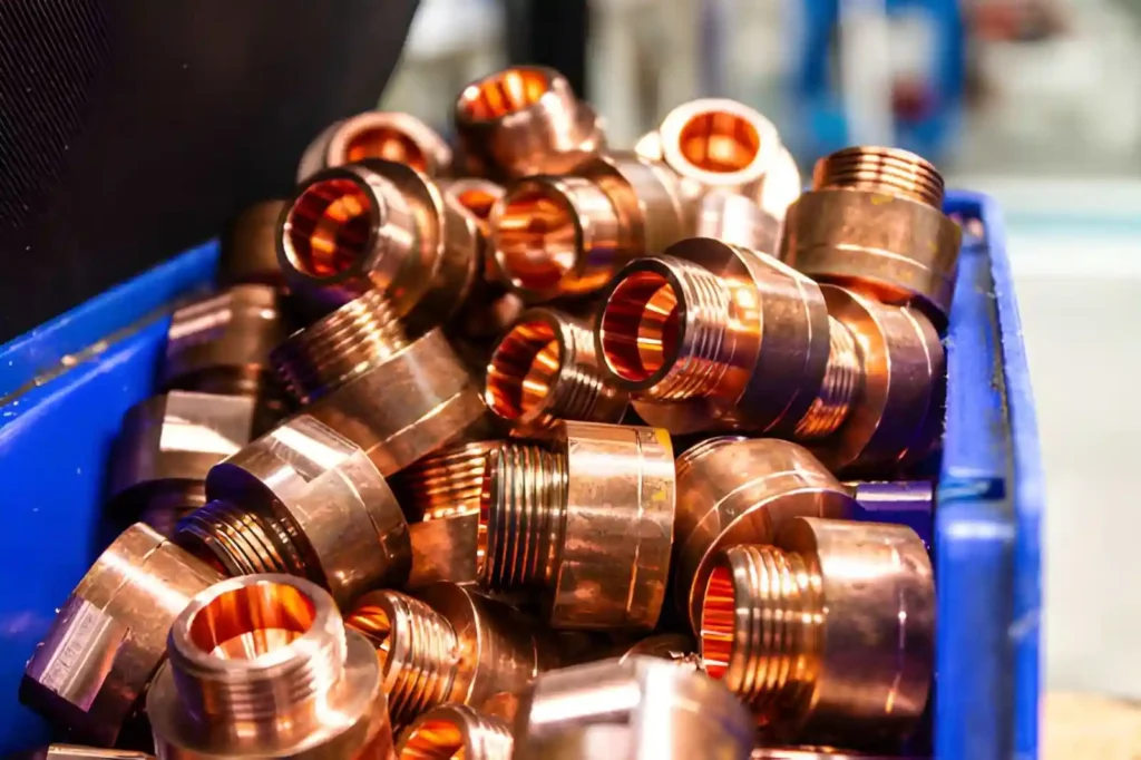 Copper round parts with a golden-brown finish, cut into pieces with threaded tapered ends.
