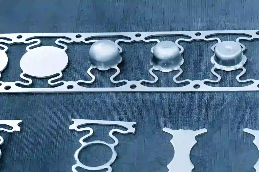 The image shows sheet-metal parts formed by deep-draw stamping.