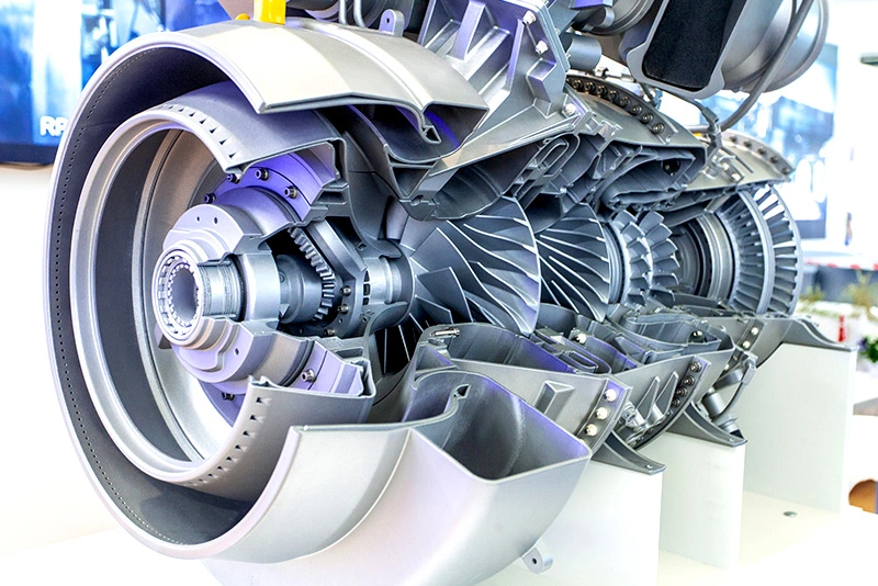 Cross-section model of a jet engine showing internal turbine and compressor components