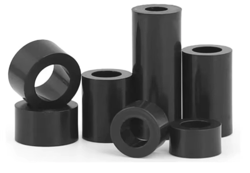 Black PVC turned cylindrical spacers with drilled center bores, in varying heights and diameters