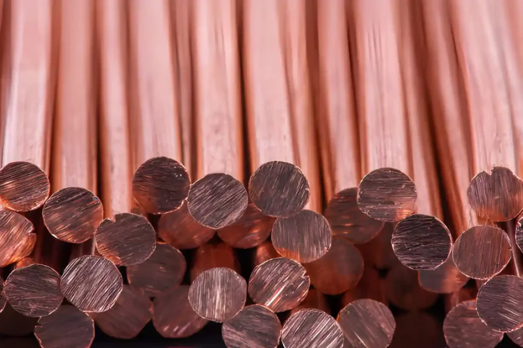 Raw pile of copper rods ready for machining.