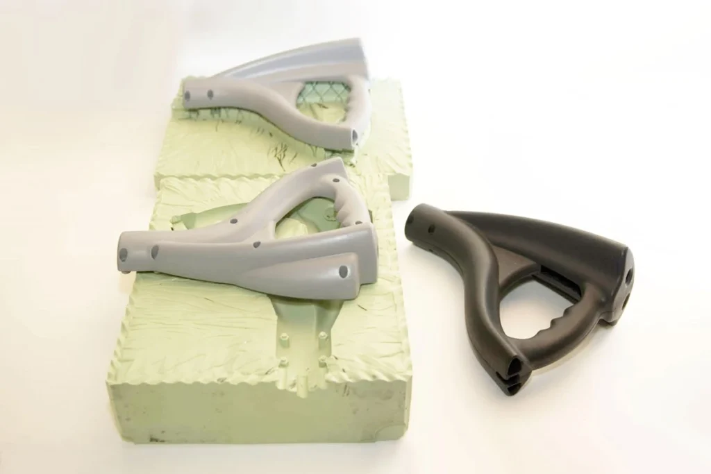 The image shows a silicone rubber mold with a cast part displayed.