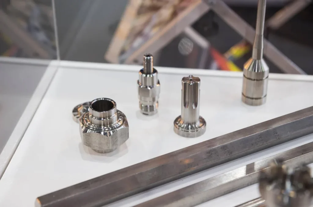 The image displays stainless steel prototype parts for aerospace use