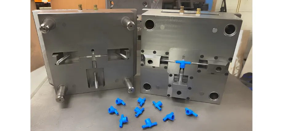 A freshly molded plastic prototype being ejected from the tooling.