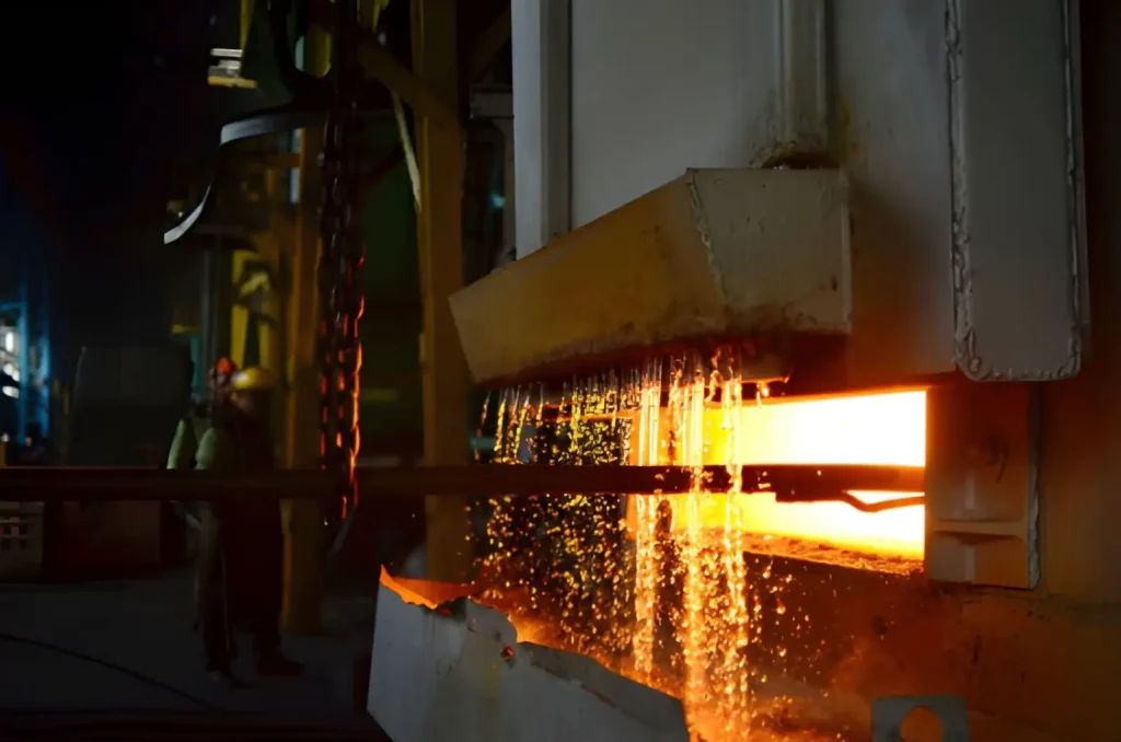 The image shows steel being heated to a high temperature in an industrial furnace as part of the quenching process.