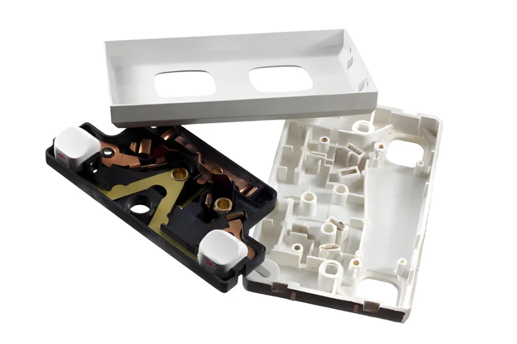 Black or white wall switch with molded plastic housing and buttons.