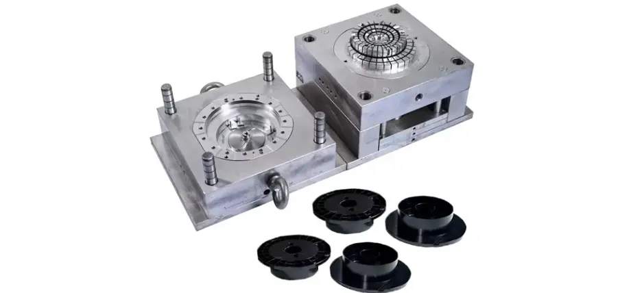 A two-part metal injection mold core and cavity block showing multiple matching geometric slots, runners, and brass water line connectors.