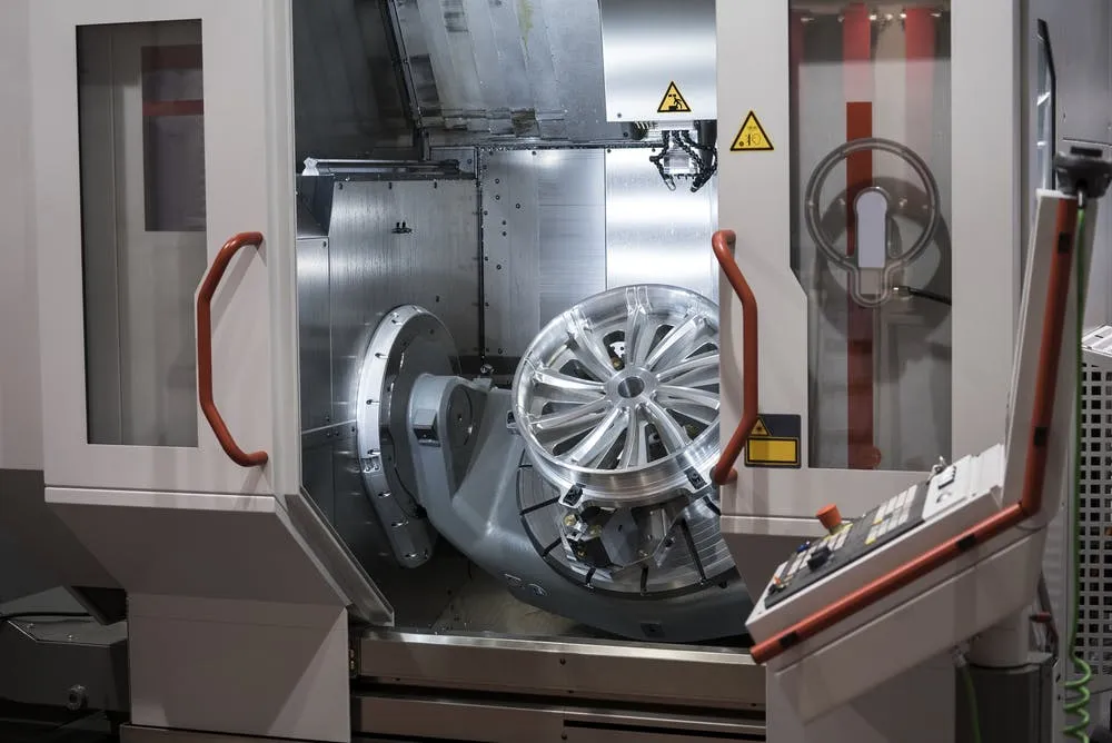 CNC turning machine processing a metal component for medical manufacturing