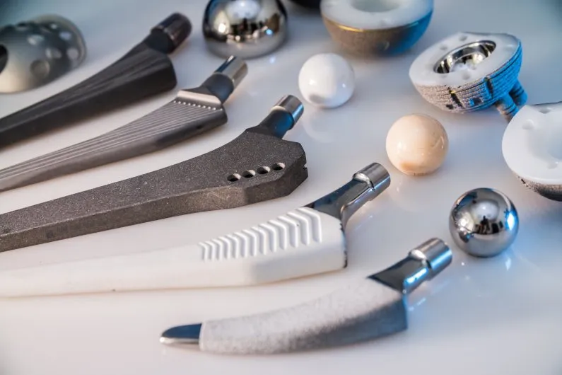 Various CNC-machined medical implant components, including hip stems and joint parts