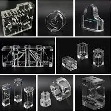 Grid of various metal and transparent machined components on a black background.