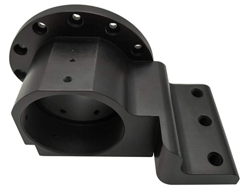 Black Delrin CNC-machined flange mount with bolt holes and a cylindrical housing. 
