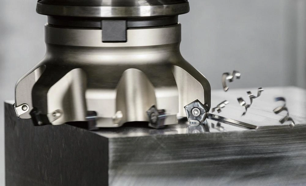 A close-up view of a face mill cutter removing material from a workpiece