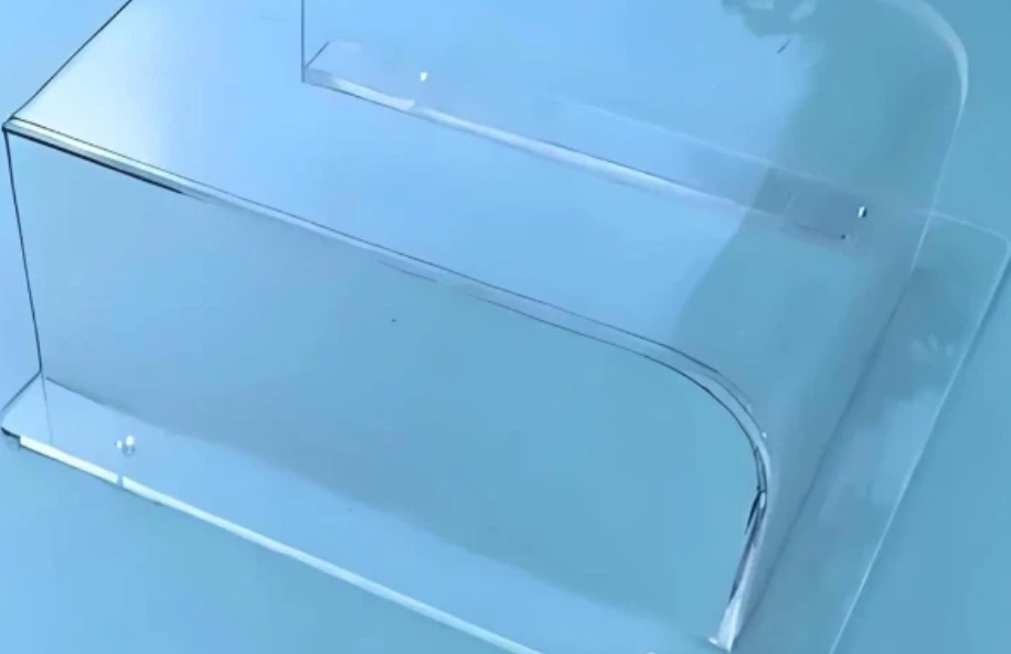 Clear glass-filled polycarbonate box enclosure with rounded corners and screwed side panels.