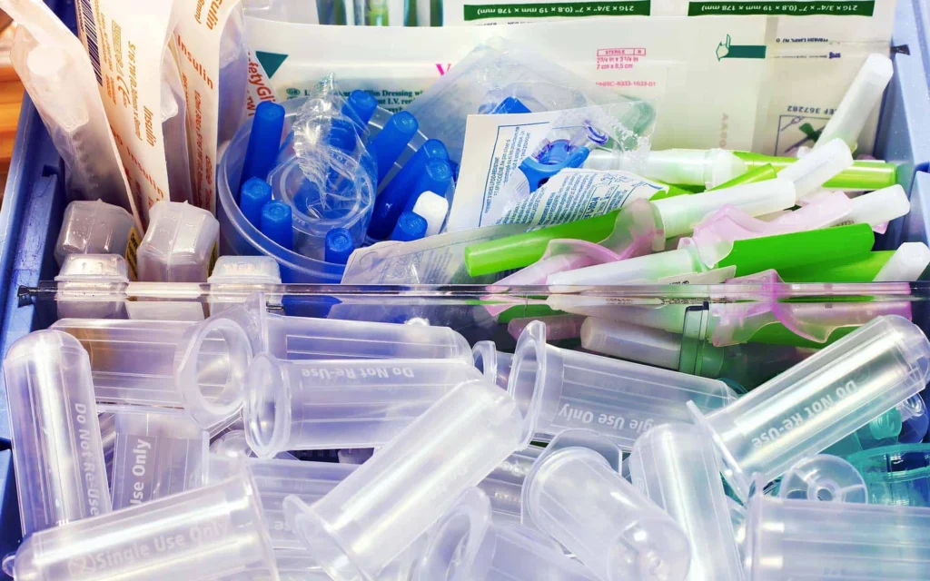 Drawer filled with single-use plastic medical supplies and syringes