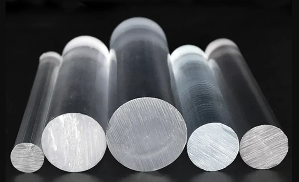 Multiple clear polycarbonate rods of varying diameters on a dark background.