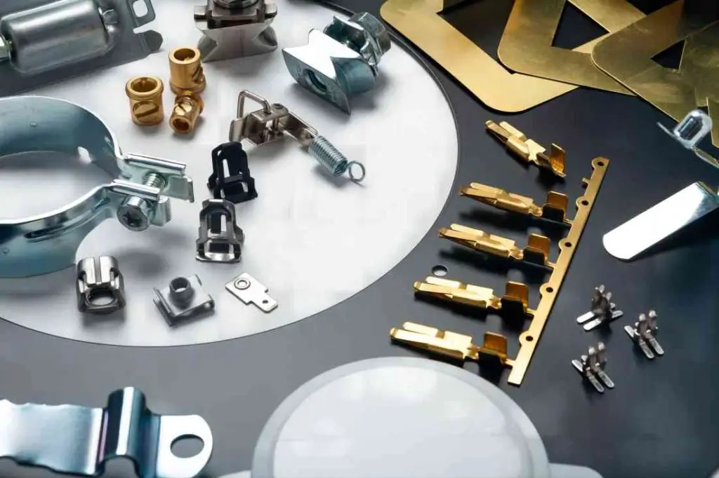 A variety of small stamped metal parts neatly arranged on a work surface