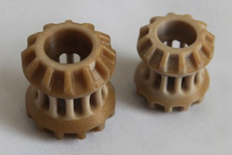 Two 3D-printed PEEK spinal cage implants with visible layer lines and lattice structure