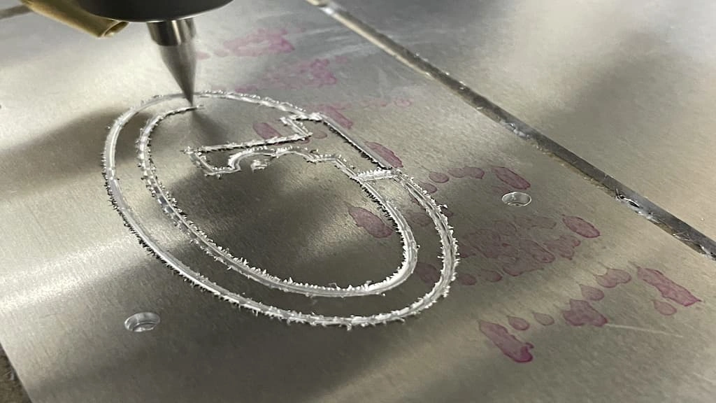 A close-up view of aluminum melting while engraving