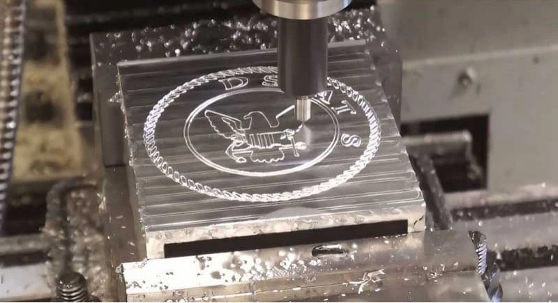 A close-up view of the diamond-drag CNC engraving process