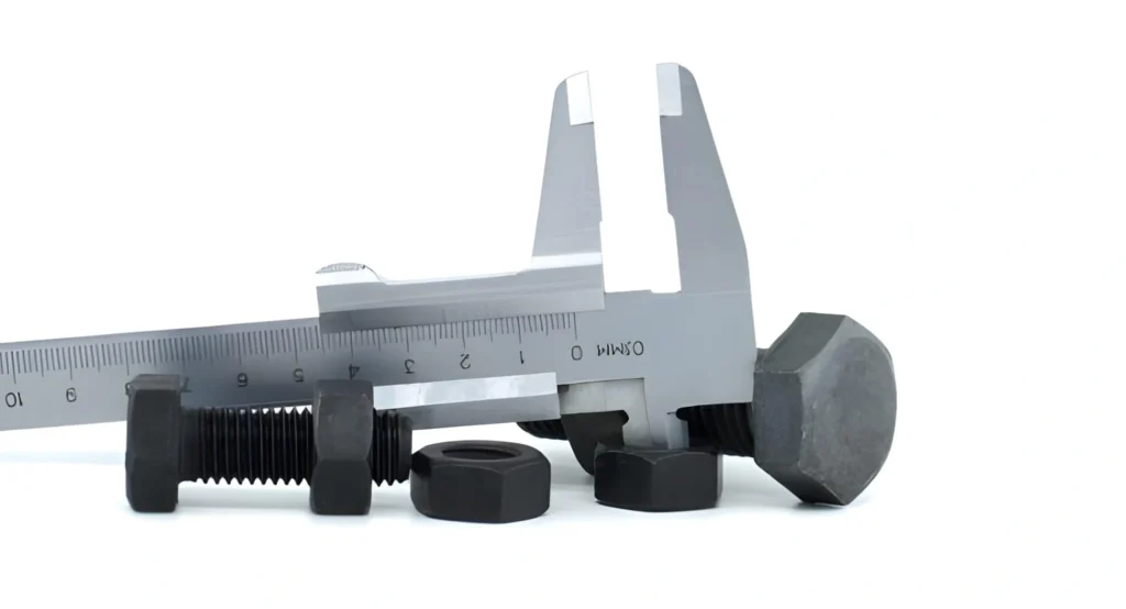 Close-up of a caliper measuring a metal nut.