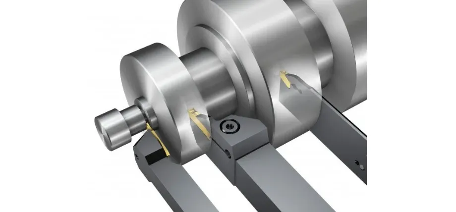 A 3D CAD rendering illustrating multiple cutting tools simultaneously machining grooves into a steel engine crankshaft.