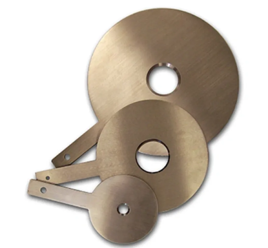 Three laser-cut brass HVAC orifice plates of varying sizes with precision-cut center holes for flow control 
