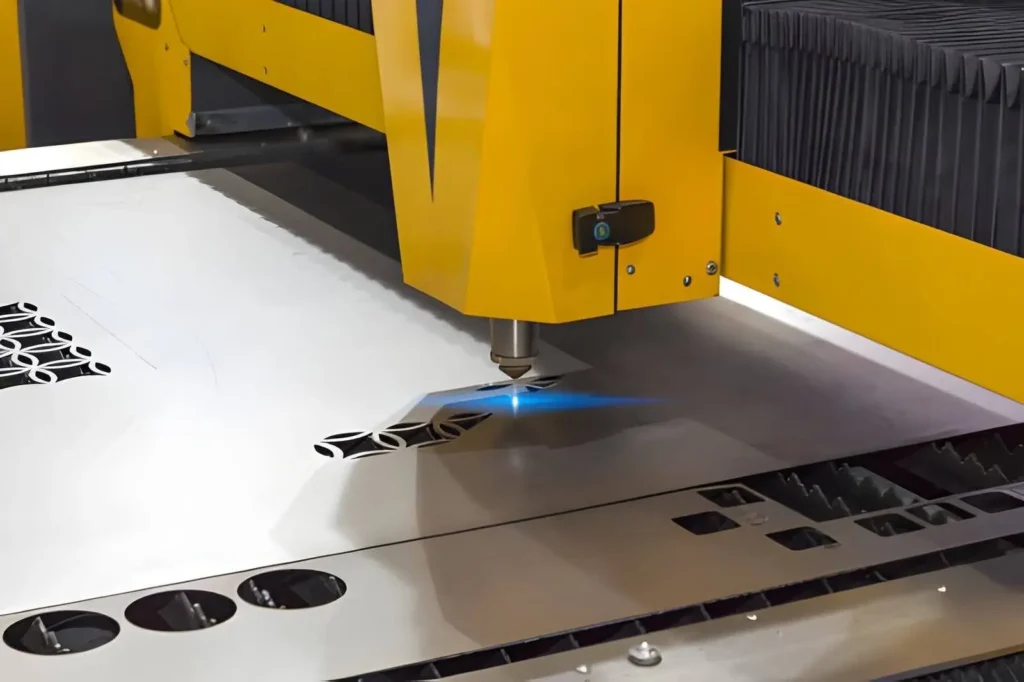  The image shows a laser cutting process creating a complex design on a metal sheet.