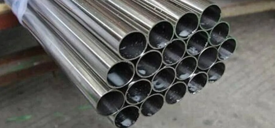 A bundled stack of hollow, polished stainless steel pipes showing reflective circular cross-sections.