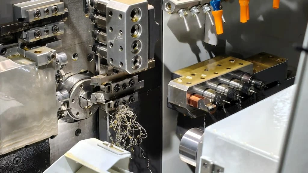  The image compares a close-up view of Swiss machining & traditional CNC machining setups