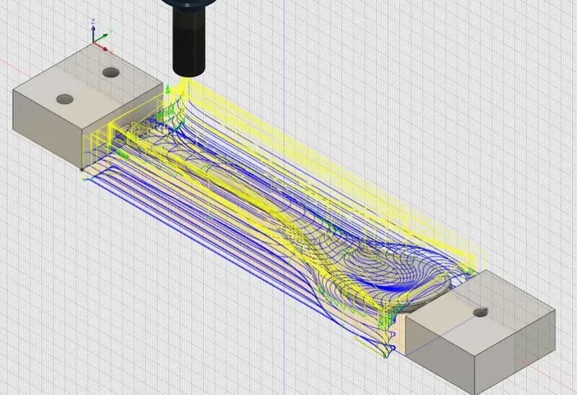 CAM simulation showing adaptive clearing toolpaths with curved blue and yellow passes across a fixtured workpiece. 