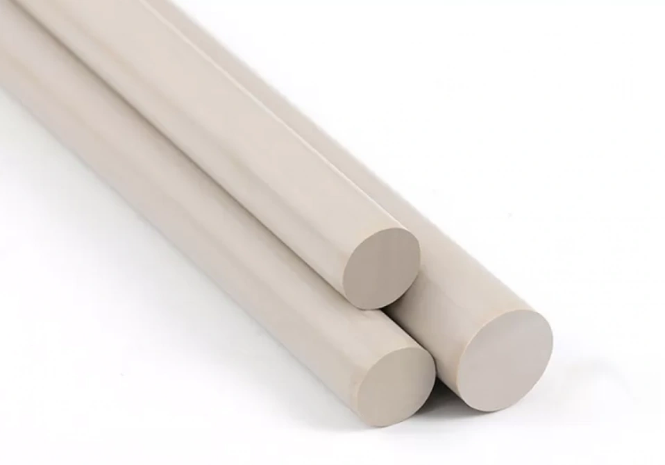 Three medical-grade PEEK round bar stock rods on a white background