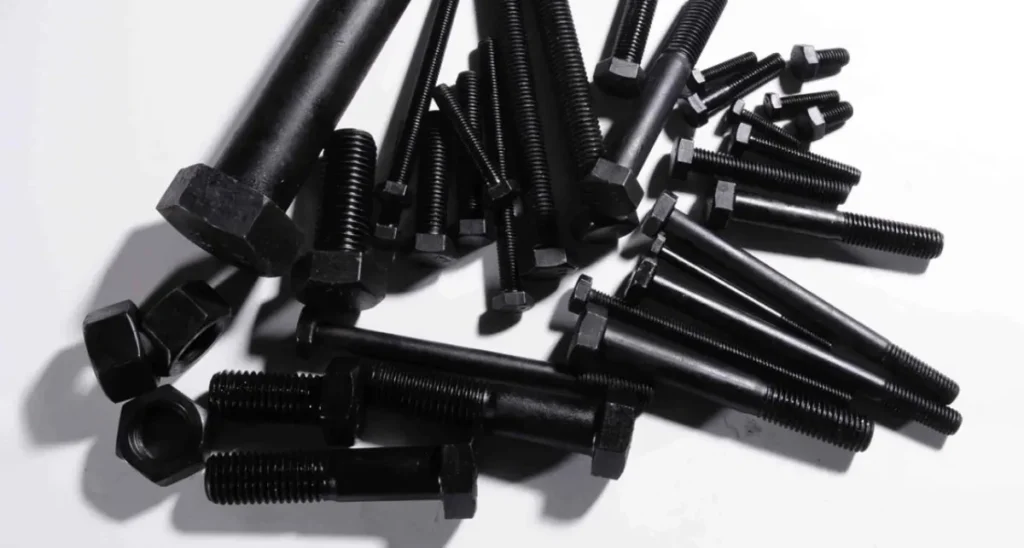 A pile of hex bolts, studs, and nuts with a matte black oxide coating finish