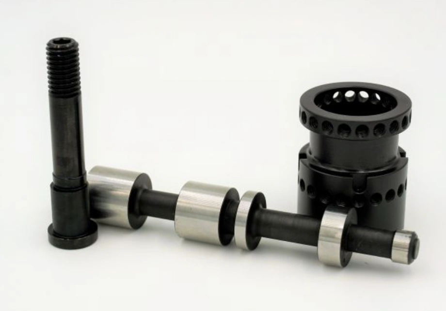 Black oxide-finished precision-machined shafts and cylindrical housing with bare steel bearing surfaces