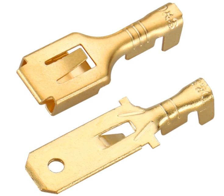 Two precision-cut brass electrical connector terminals showing male and female components with clean laser-cut edges. 