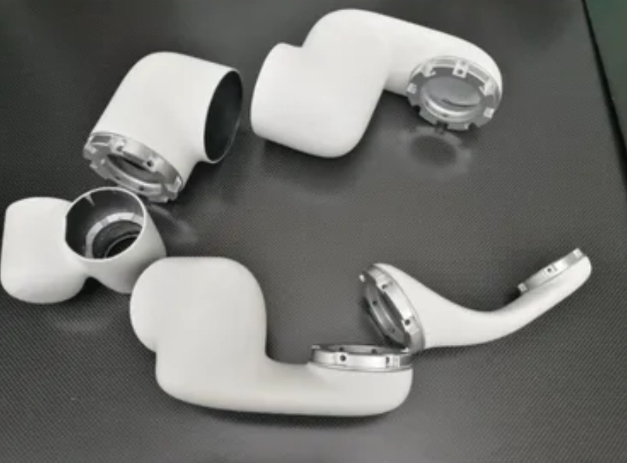 White CFRP robotic arm segments with precision-machined aluminum joint flanges