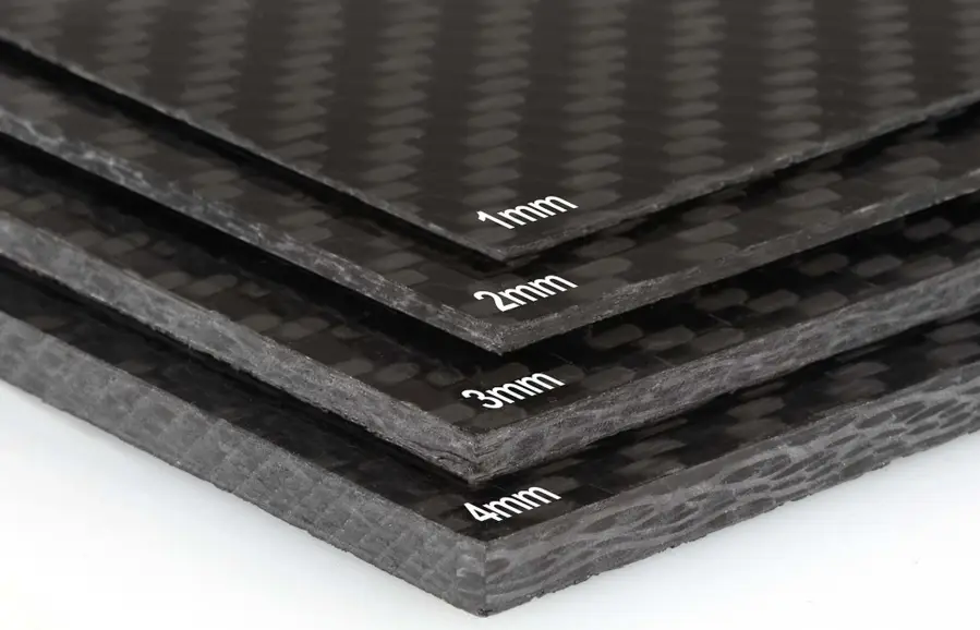 Four stacked woven carbon fiber sheets in graduated thicknesses labeled "1mm," "2mm," "3mm," and "4mm."