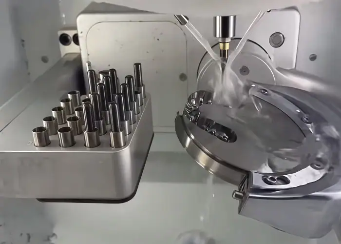 Coolant spraying on a rotating metal part inside a CNC machine.