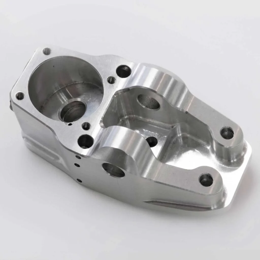 Close-up of a CNC-machined aluminum bracket with precision-drilled holes