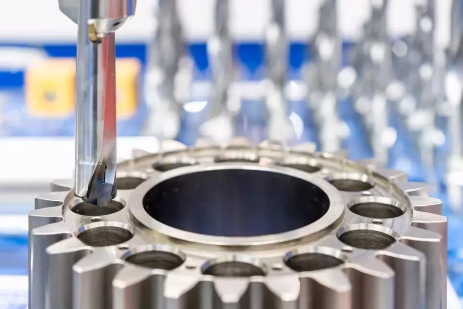 Boring tool precision-machining a large-diameter hole in a gear-like cylindrical metal workpiece on a jig boring machine