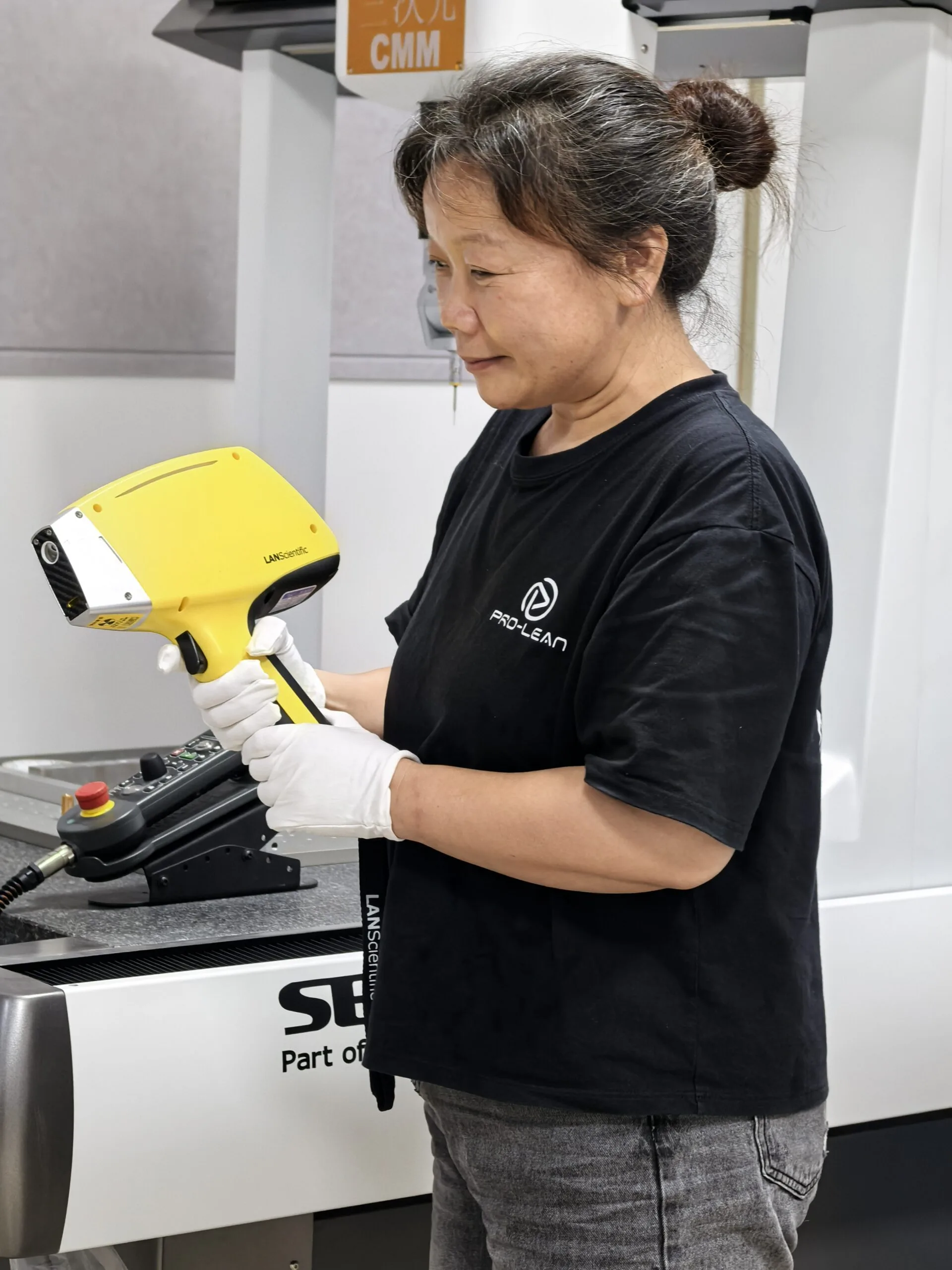ProleanMFG quality technician performing in-house alloy verification with a handheld spectrometer