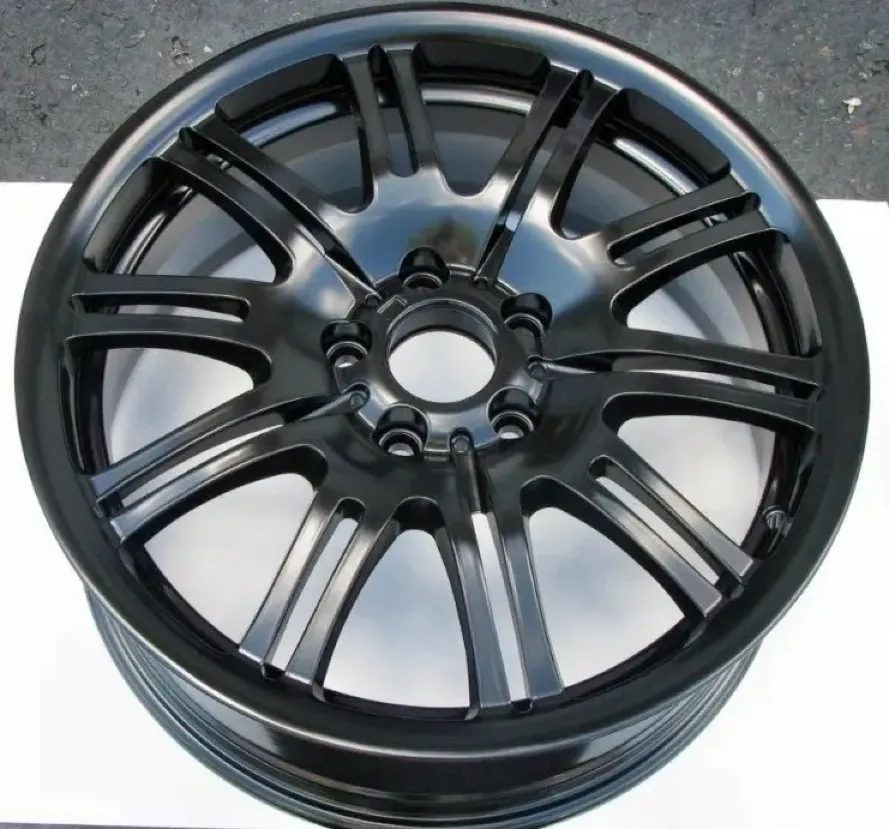 Multi-spoke automotive alloy wheel with a smooth matte black powder coat finish