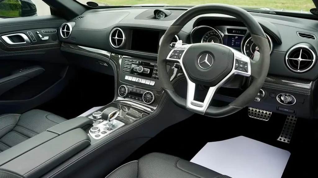 Automotive interior with ABS plastic dashboard, steering wheel trim, and vents