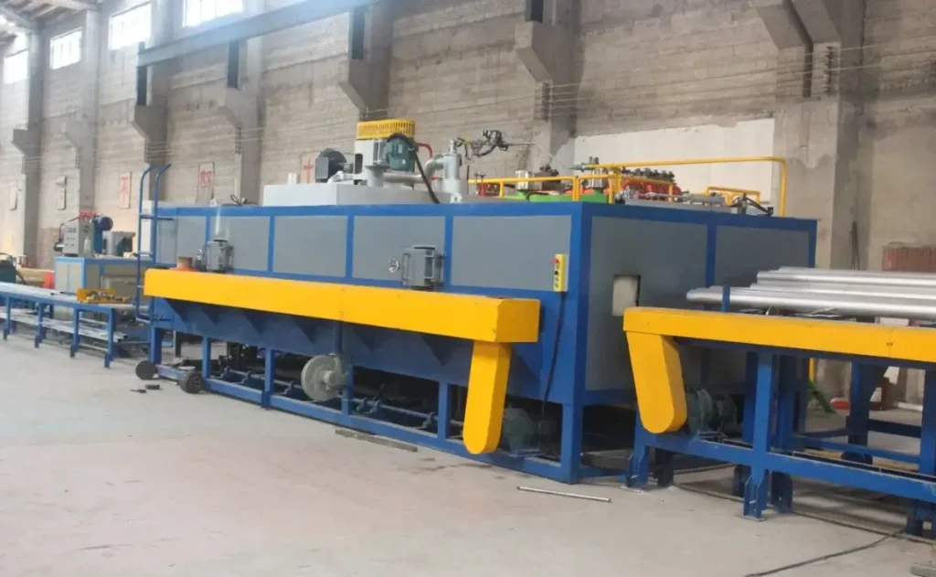 Industrial aluminum billet preheating furnace with roller conveyor in a factory setting  