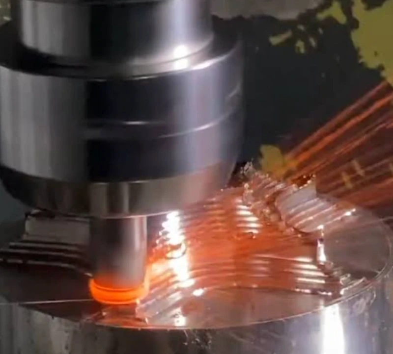 CNC end mill machining Inconel 625, cutting edge glowing red-hot with sparks