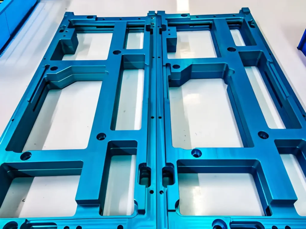 Stainless steel screws arranged on blue chrome-coated metal plates, showing their shiny finish and organised layout.