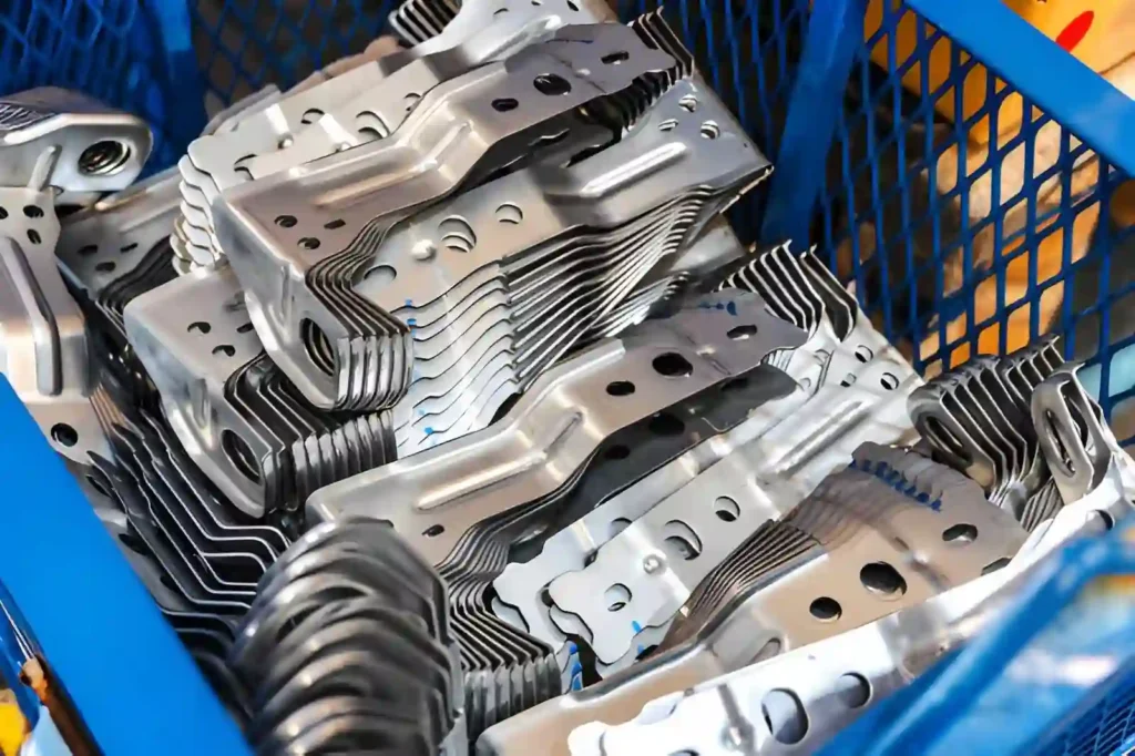 Bent steel metal components formed through sheet metal bending, showing curved edges and shaped profiles.