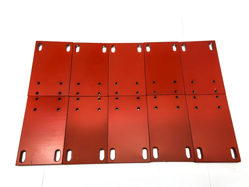 Round steel plates with a chrome finish, coated in red, arranged together to show their smooth surfaces and metallic shine.