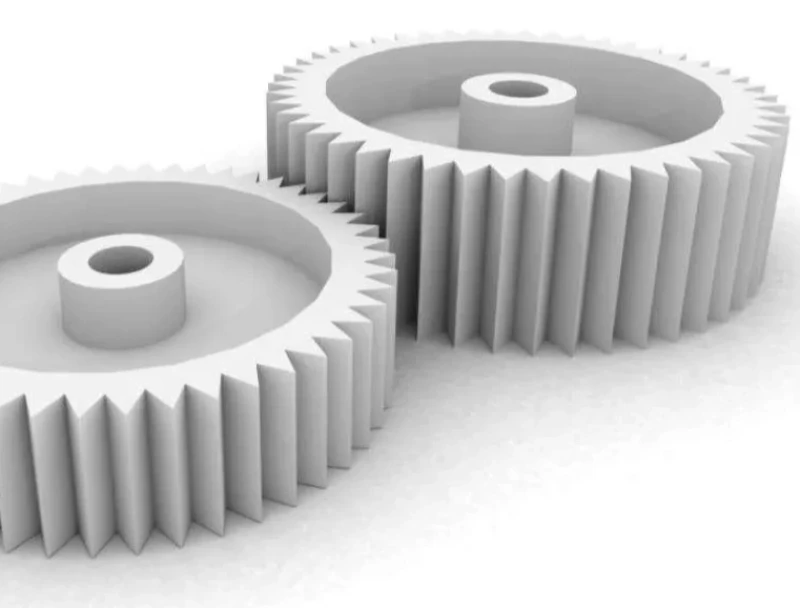 Two white acetal gears meshed together, illustrating low-friction sliding and rotation 