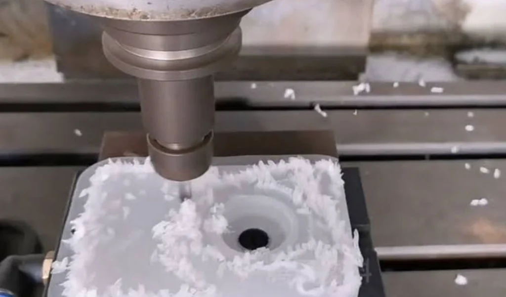 Milling spindle cutting polypropylene block with stringy chip buildup 